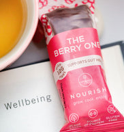 The Berry One bar with a cup of tea and a book on a table